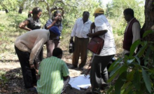 Rachael Knight/Namati: Community members and government technicians consult a community map as they take GPS coordinates of the boundaries of community land